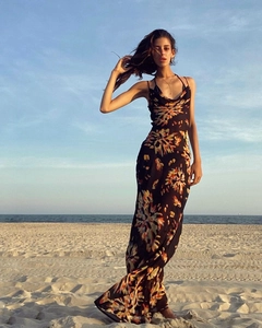 Close-up of the cowl neck detail and orange floral print on a black summer maxi dress