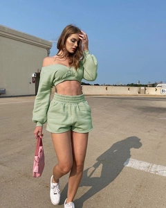 Detail of light green two-piece lounge set with off-shoulder top and high waist shorts