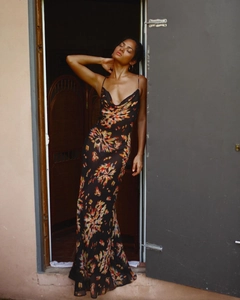 Close-up of elegant cowl neck and vibrant floral print on a long black backless dress