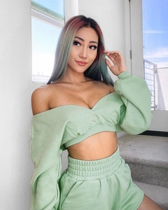 Detail of mint green V-neck off-shoulder sweatshirt with metal eyelet and shorts