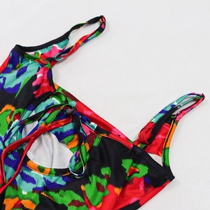 Close-up of vibrant floral print halter neckline with drawstring and cutout detail