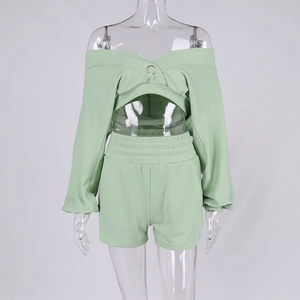 Detail of light green V-neck long sleeve crop top with metal ring and matching shorts set