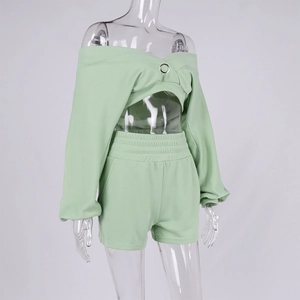 Detail of mint green two-piece set featuring off-shoulder top with metal ring buckle