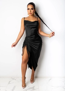 Detail of black satin slip dress showing side drawstring ruching and high slit design