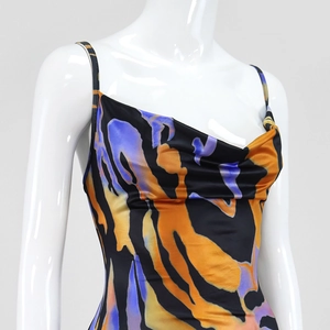 Detail view of the cowl neck and abstract colorful print on a satin summer maxi dress