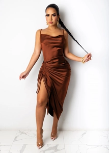 Detail of satin dress featuring a cowl neck and side drawstring ruched high slit