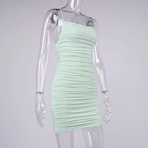 Close-up of mint green ruched bodycon dress with spaghetti straps and textured fabric