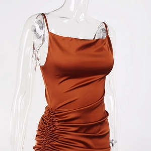 Detail of satin slip dress featuring elegant side ruching and draped cowl neckline
