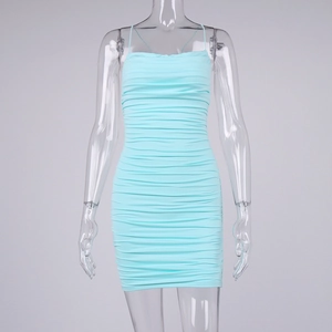 Detail of light blue ruched mini dress showing elastic bodycon fabric and side texture