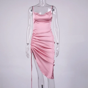 Detail of pink satin dress featuring a cowl neck and side drawstring ruched hem