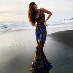 Bohemian backless halter maxi dress with blue and yellow tiger print on a beach