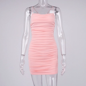 Detailed view of pink ruched bodycon mini dress with backless design and cross straps