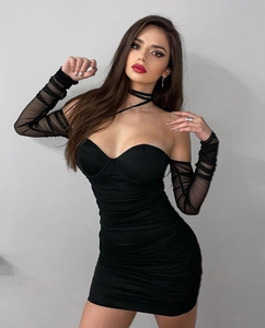 Detail of black mesh off-shoulder dress with long sleeves and ruched body texture