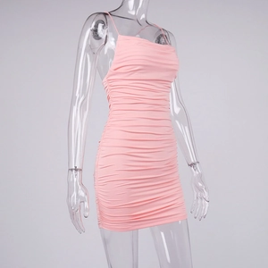 Detailed close-up of light pink ruched bodycon dress with delicate spaghetti straps