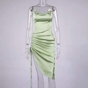 Detail of light green satin slip dress with adjustable drawstring ruching and slit
