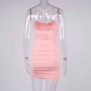 Detail view of pink ruched mini dress with sexy criss-cross back straps and elastic fabric