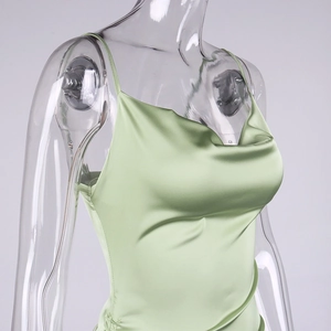 Detail of light green satin slip dress featuring cowl neck and side drawstring ruched seam