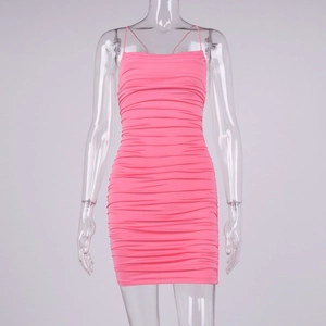 Detailed view of the ruched texture and elastic fabric on this hot pink mini dress