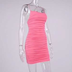 Detail of hot pink ruched bodycon dress showing elastic fabric and spaghetti straps