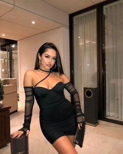 Close-up of sheer mesh sleeves and ruched details on a slim black bodycon dress