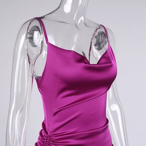Detail of rose red satin dress featuring a cowl neck and delicate spaghetti straps