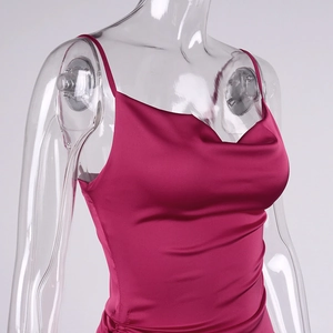 Detail of rose pink satin dress featuring a cowl neckline and silky draped fabric
