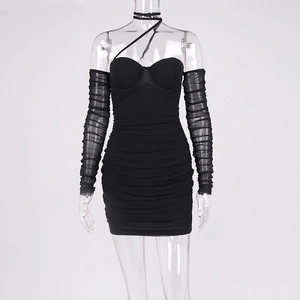 Detail of black bodycon dress with ruched fabric and sheer mesh long sleeves