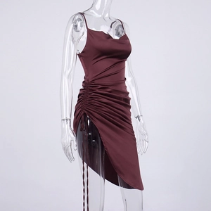 Detail of wine red satin dress featuring cowl neck, side drawstring, and high slit