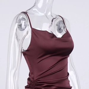 Detail of burgundy satin dress showing cowl neck and drawstring side ruching texture