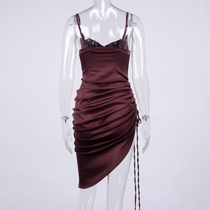 Detail of burgundy satin dress showing delicate straps and pleated back tailoring