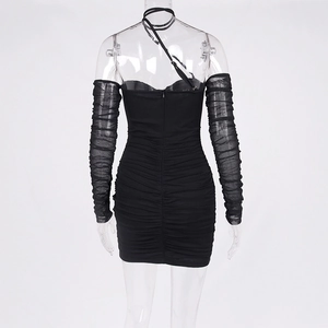 Detail of the back invisible zipper and pleated mesh sleeves on this black mini dress