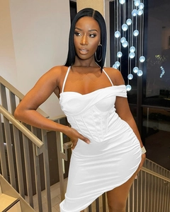 Detailed view of white satin corset dress with ruched texture and asymmetric hemline