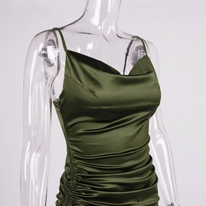 Detail of ruched dark green satin dress showing the silky texture and fine drawstring side