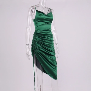 Detail of emerald green satin dress featuring cowl neck and side drawstring ruching