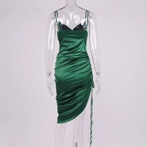 Detail of deep green satin dress featuring ruched drawstring sides and backless cut
