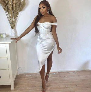 Detail of white satin dress featuring an asymmetrical hem and elegant corset bodice structure