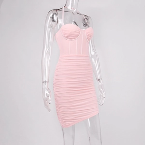 Detail of pink ruched bodycon dress with bustier corset design and thin spaghetti straps
