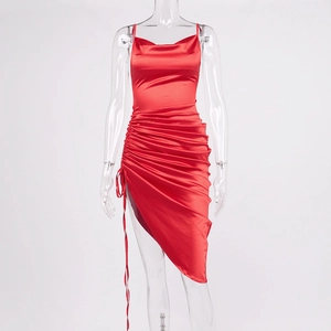 Detail of red satin dress featuring cowl neck and adjustable ruched side drawstrings