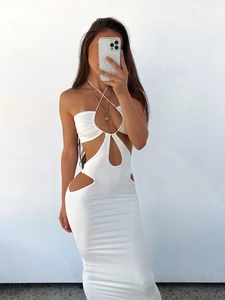 Detail view of white halter neck maxi dress with sexy cutout design and lace-up back