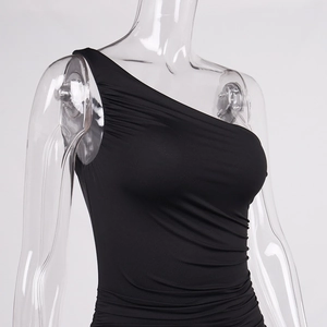 Detailed view of the asymmetrical ruched shoulder design on a black bodycon dress