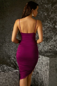 Back view of a purple ruched bodycon dress with spaghetti straps and asymmetrical hem