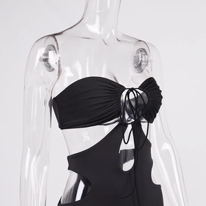 Detail of black cutout monokini featuring strapless bandeau neckline and waist cutouts