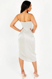 Detail view of the open back satin dress with elegant golden chain shoulder straps