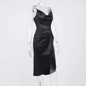 Close-up of black satin dress with metal chain straps, cowl neck and side ruching detail