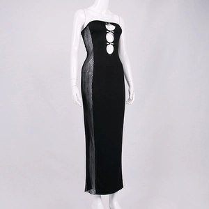 Detail of sheer mesh paneling and metallic buckle on a black strapless bodycon dress