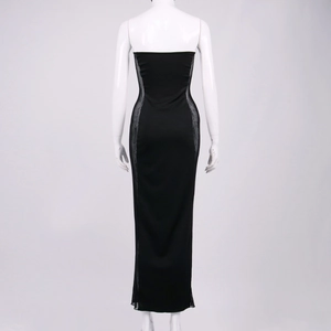 Detail showing the side sheer mesh panels on a slim-fit black strapless maxi dress