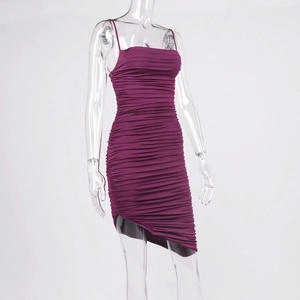 Detail of ruched burgundy mini dress featuring spaghetti straps and asymmetric hemline
