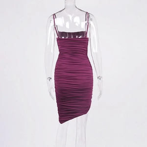Detail of ruched bodycon dress back featuring asymmetric hem in deep purple color
