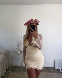 Close-up of cream bodycon dress featuring hollow-out chest design and mesh sleeves
