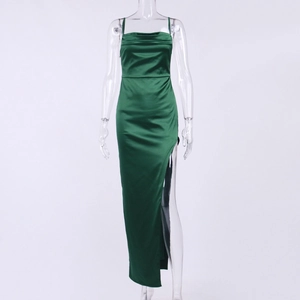 Detail of emerald green satin dress featuring high side slit and smooth silky texture
